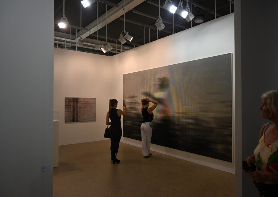 Visitors walking among gallery stands at Art Basel in Basel, Switzerland.
