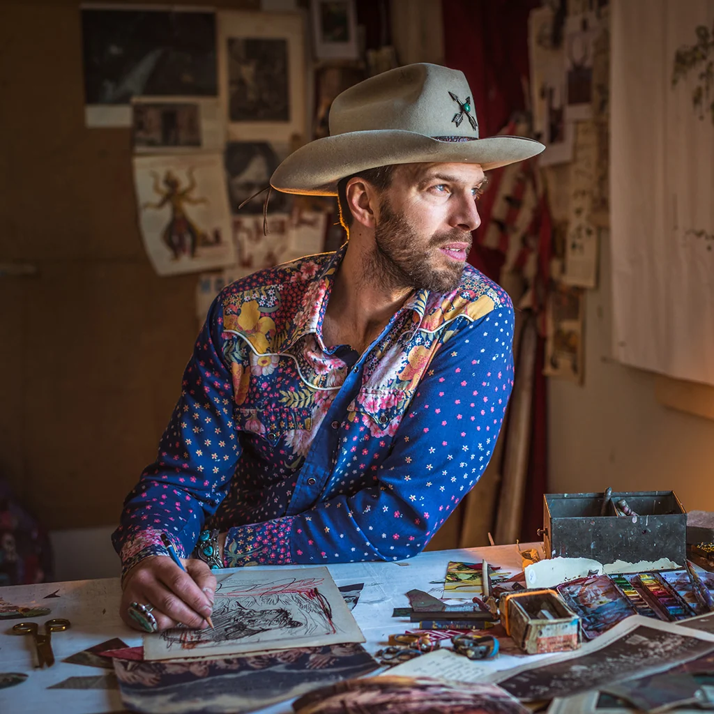 Dolan Geiman at work in his studio, wearing a hat and patterned shirt
